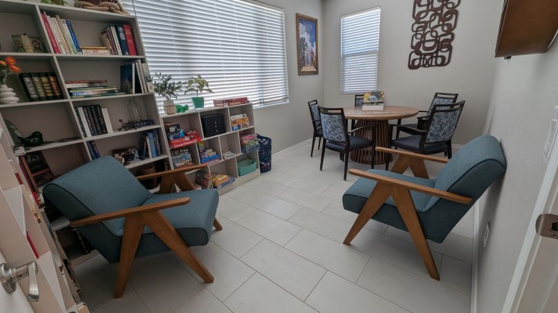 Library & Activity Room Library and activity room at Desert Willow Memory Care with books, games, and comfortable seating.